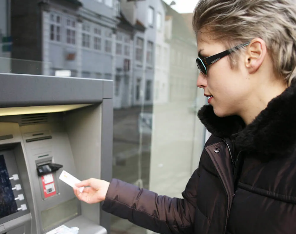 woman at payment card self-service kiosk